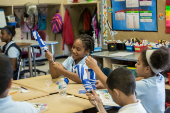 students_with_umbrellas_Lehigh_scholar_athletes_donate_umbrellas_to_tackle_absenteeism_at_local_elementary_school