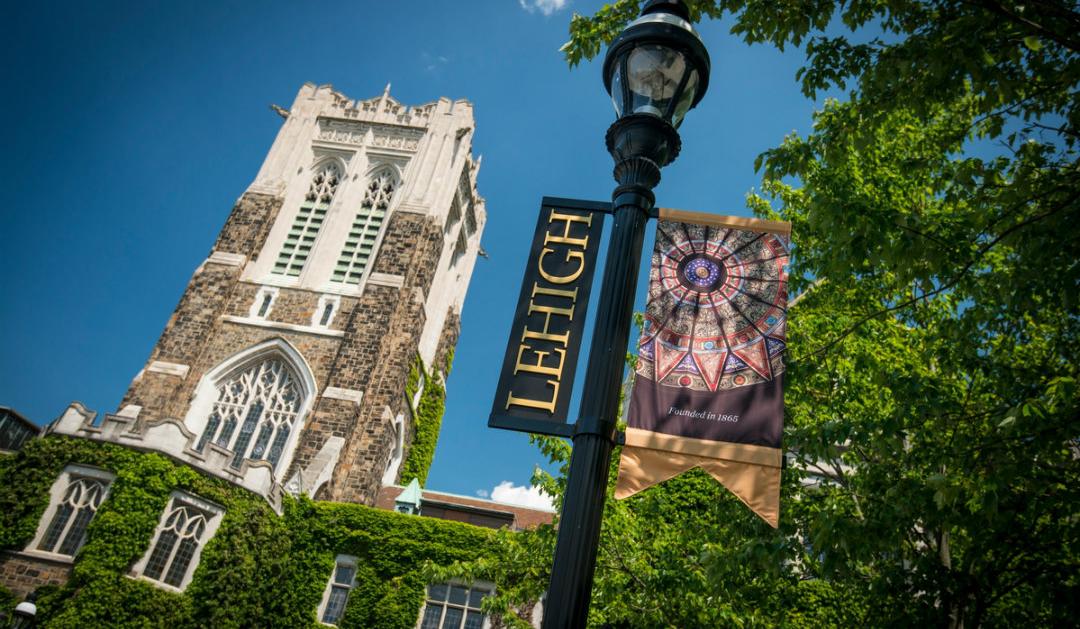Lehigh University's Alumni Memorial Building with Lehigh flag hanging in front
