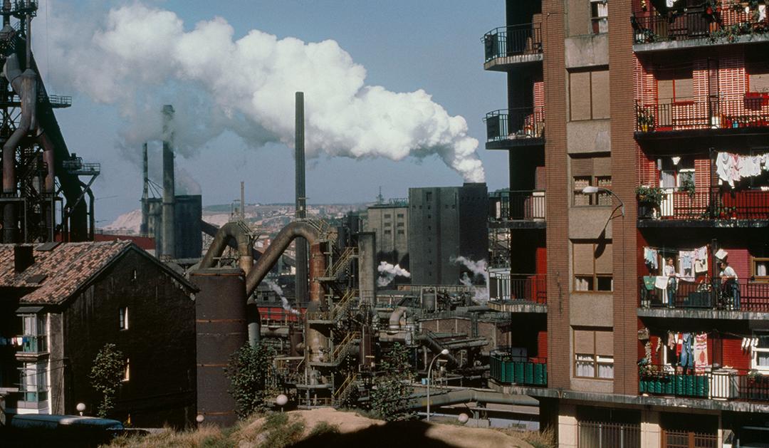 Photograph of smoke stacks in city with polluted air 