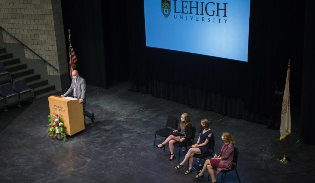 Provost Urban speaks at Lehigh University Honors Convocation, on stage in front of screen