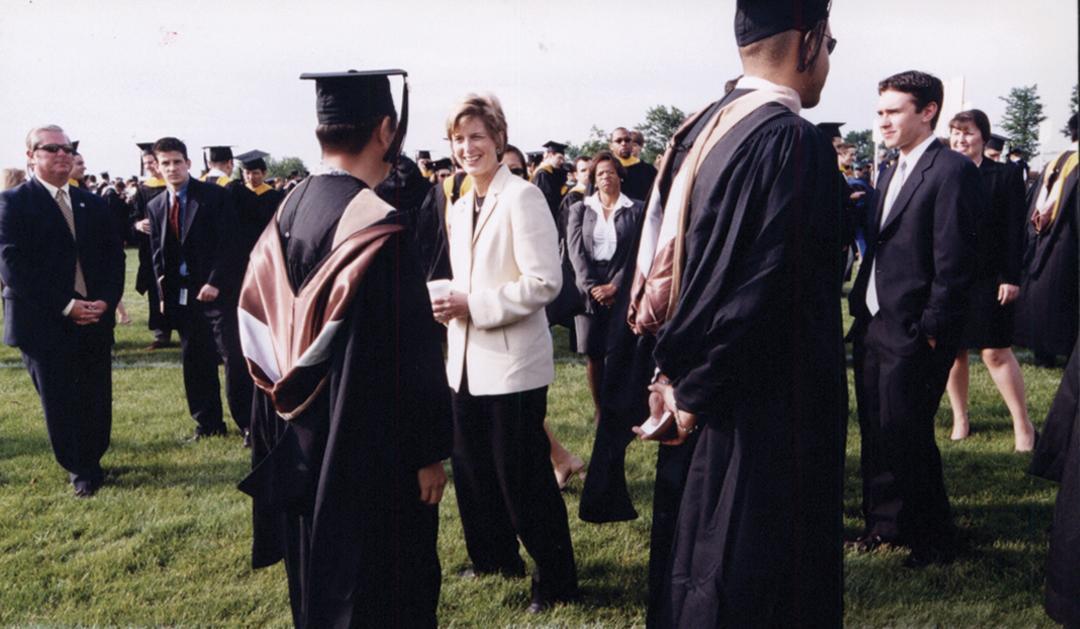 Lehigh’s 2002 Commencement speaker Christine Todd Whitman chats with a graduate on the field in Goodman Stadium. 