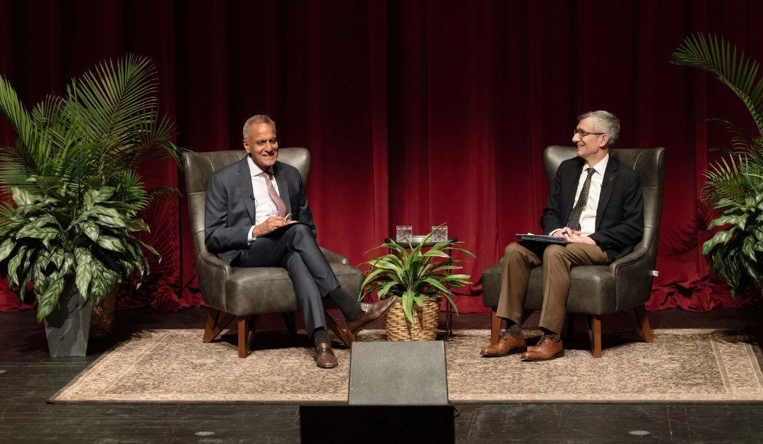 Richard Verma and Joseph Helble sit on stage during lecture