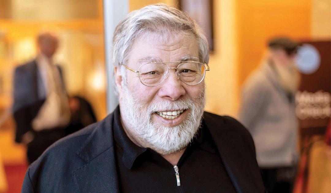 Steve Wozniak, gray-haired man with beard, glasses, black jacket.