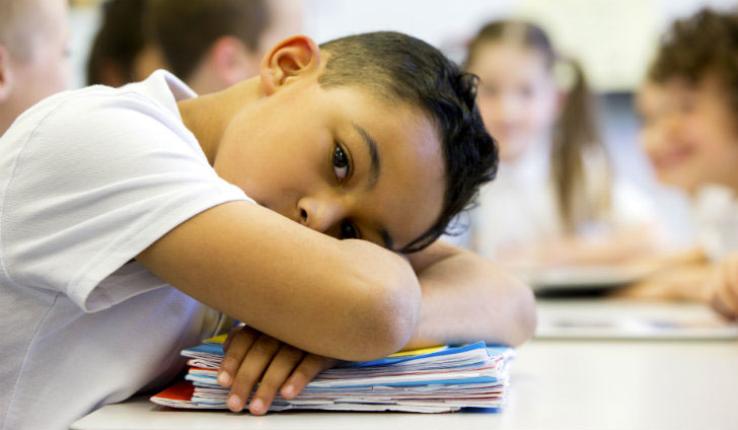 Student with head resting on desk