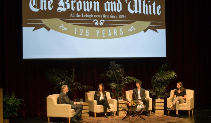Marty Baron speaks with editors from The Brown and White on stage in Baker Hall