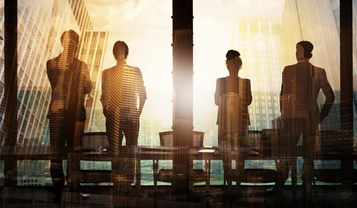 Silhouettes, including a woman, in an office