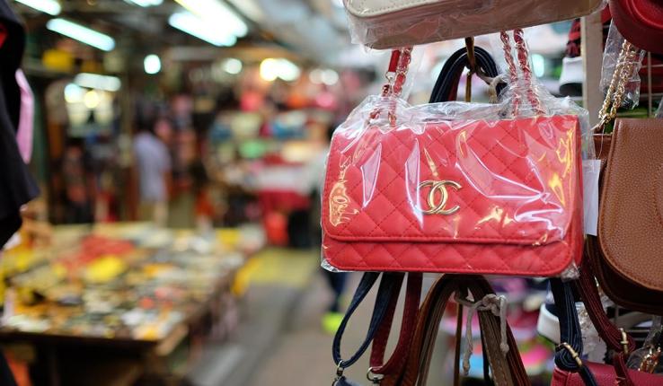 purse hanging on shopping rack in store