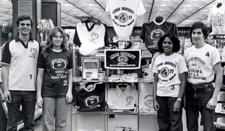 Four students model T-shirts commemorating Lehigh Football’s 1977 National Championship win.