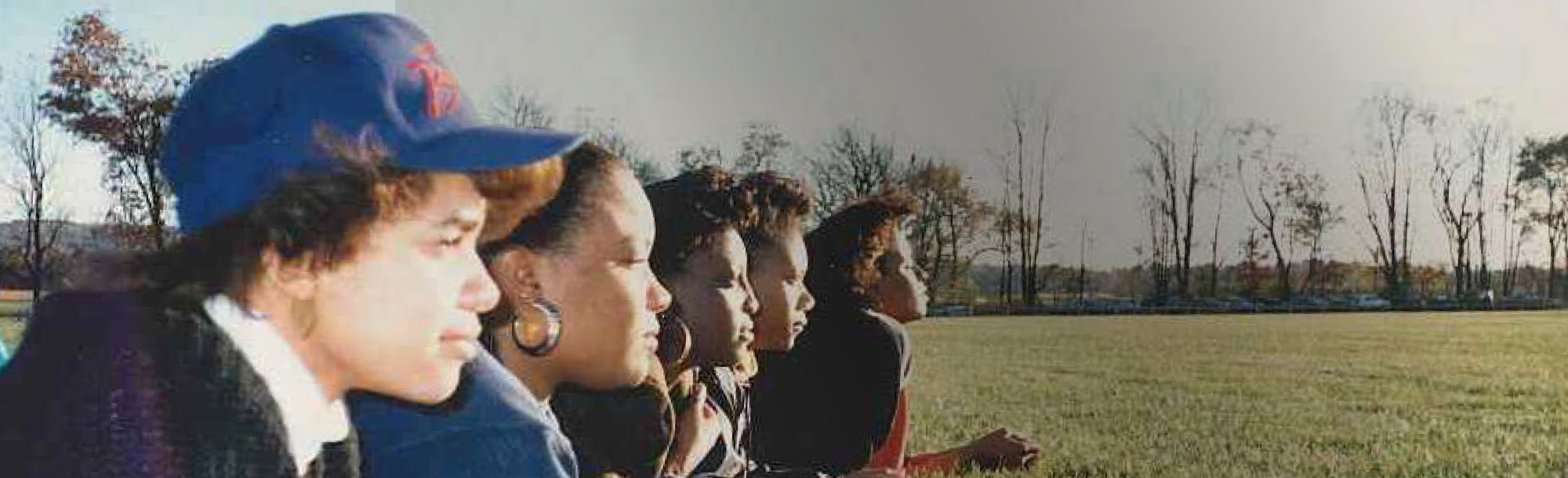 Students laying on the grass in a field