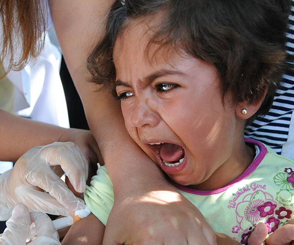 Child screaming while being given an injection in the arm