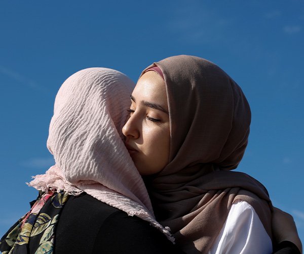 Two woman hugging each other