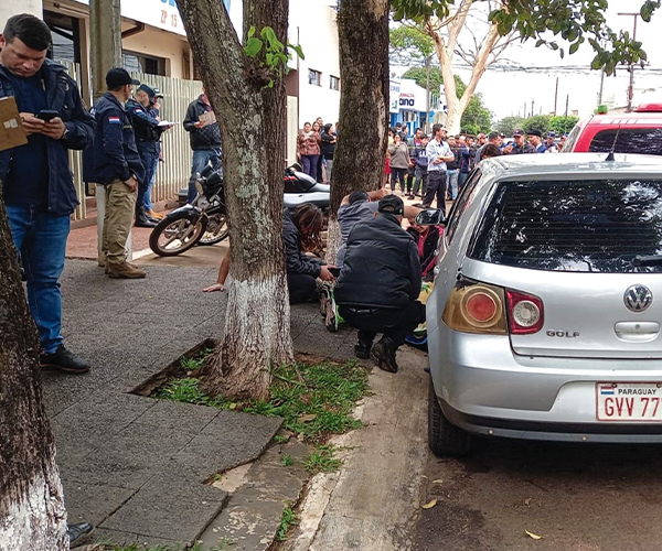 Large group of people gathered around on a street